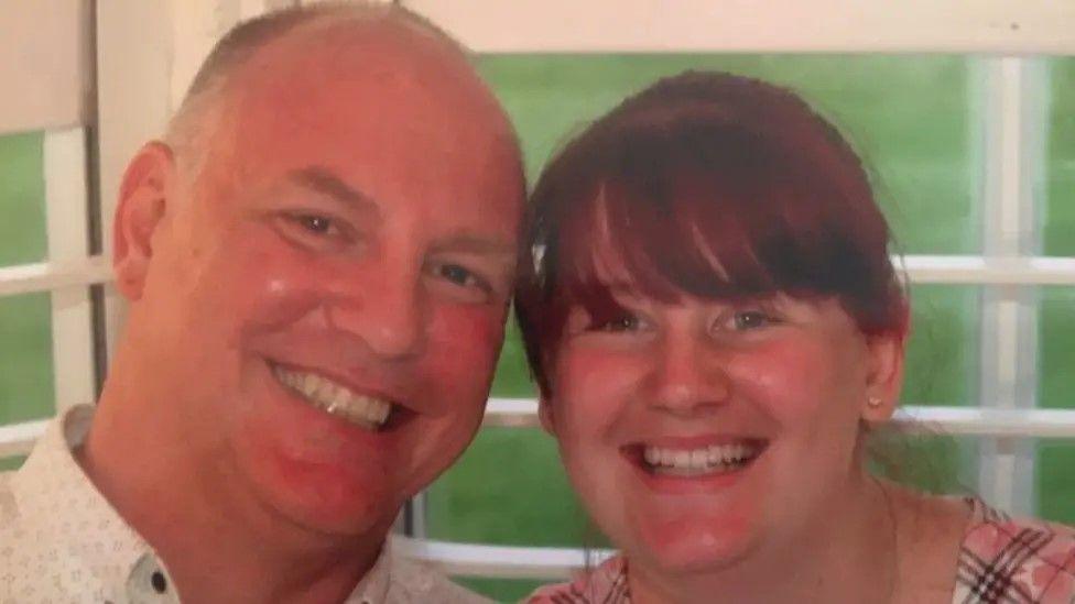 John Hewitt and daughter Kelly Hewitt, smiling at the camera