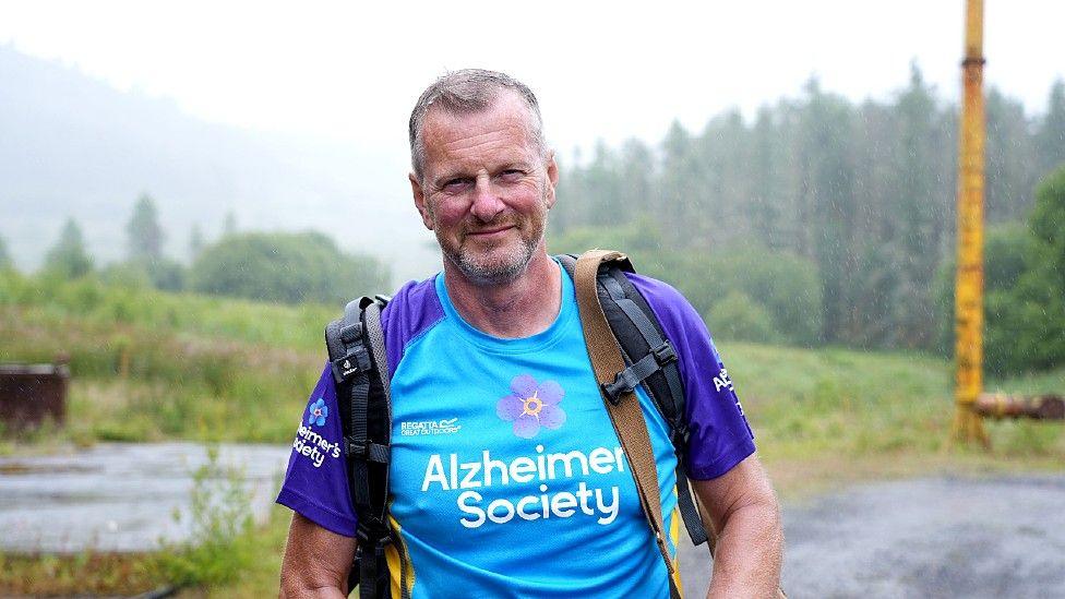 Roger Tiley walking in an Alzheimer's Society t-shirt