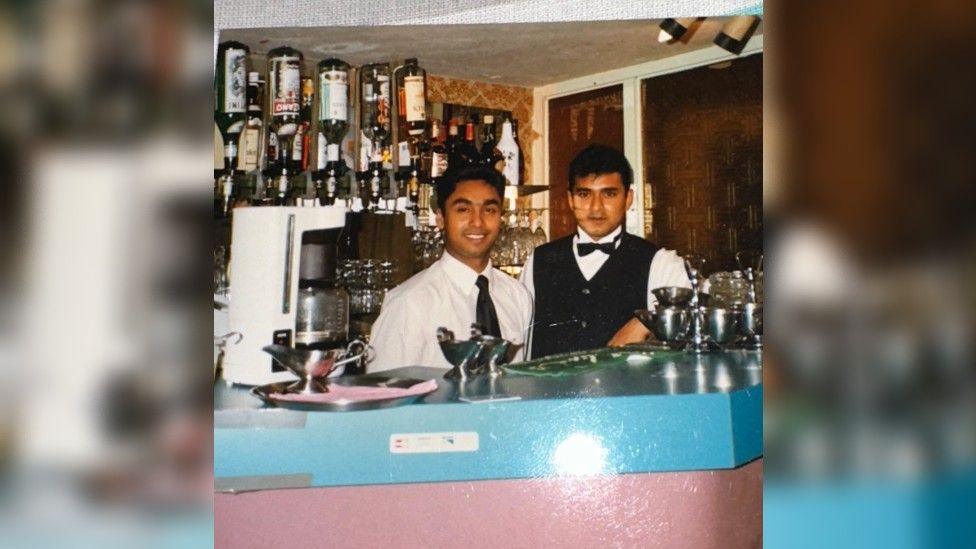 Luthfur with a colleague behind the bar in a restaurant