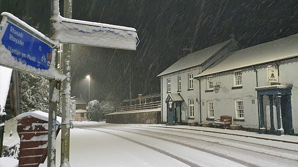 Snowy street outside a pub