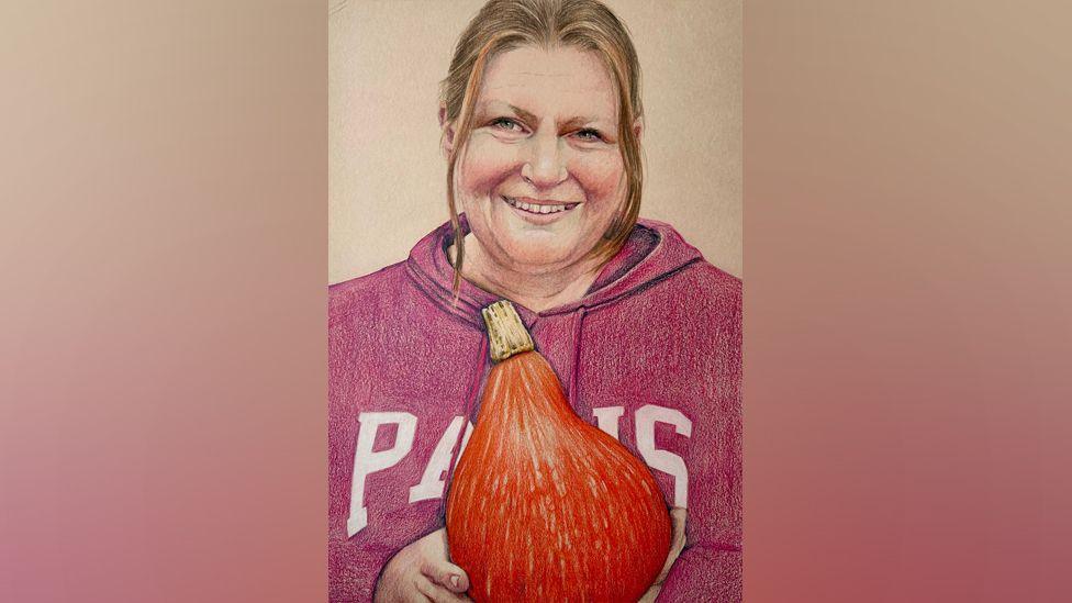 A painting of Mel, holding a pumpkin, wearing a red top, smiling at the camera, with her hair tied back.