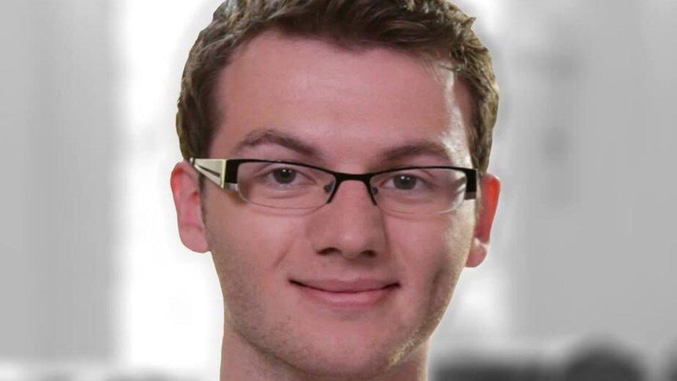 Stephen Sutton. He has short hair and square glasses. He is smiling and looking at the camera.