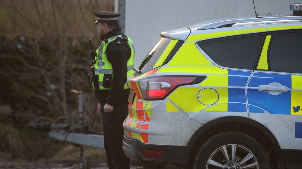 Police at the scene where Mr Low's body was discovered