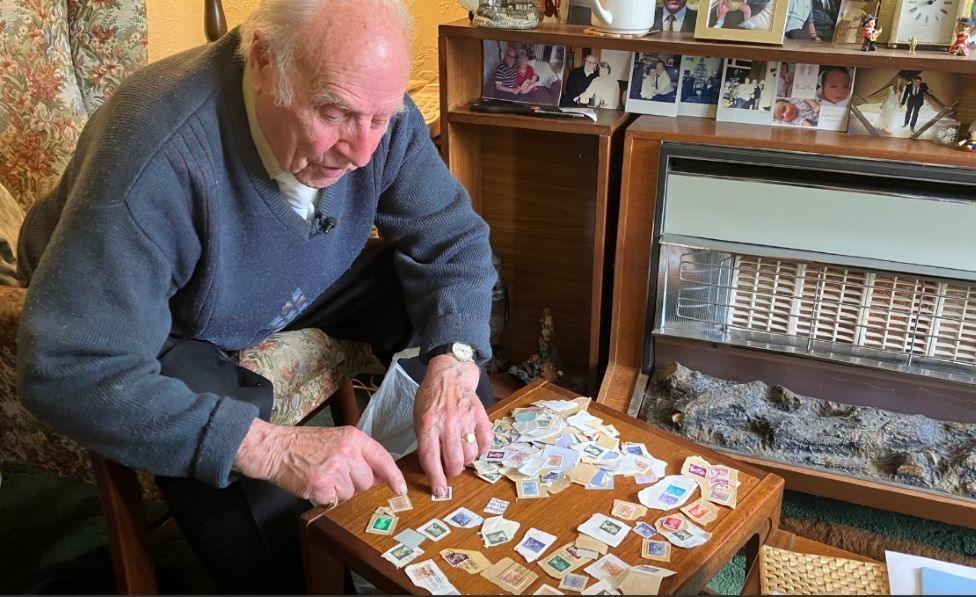 Alan Barker with some of his stamps