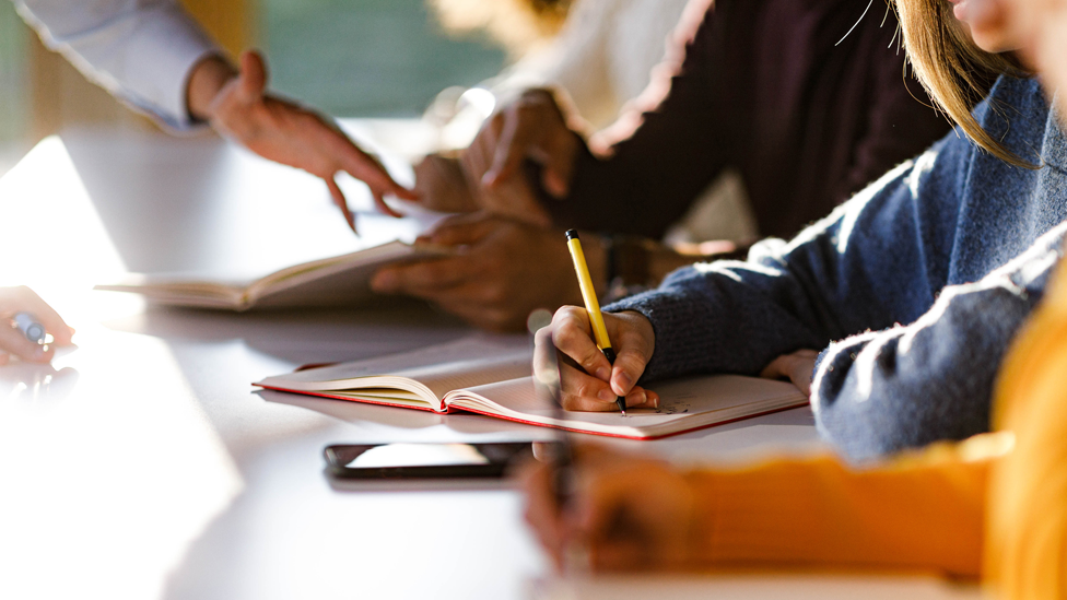 Students working with pens at their desks