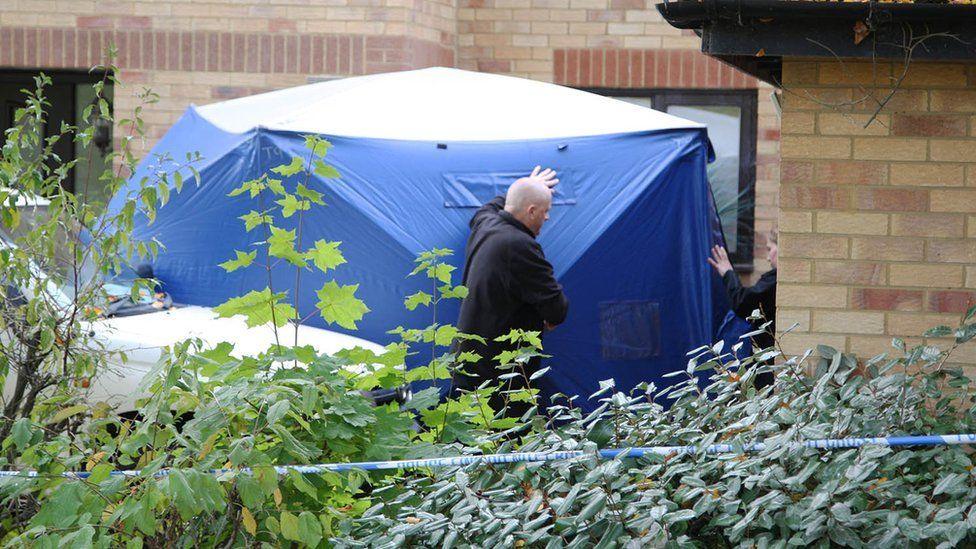 Police search a house in Milton Keynes.