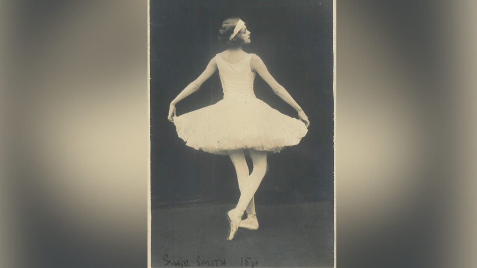 A black and white image of Sissie Smith when she was 15, showing the back of her in a dance pose, while facing the right