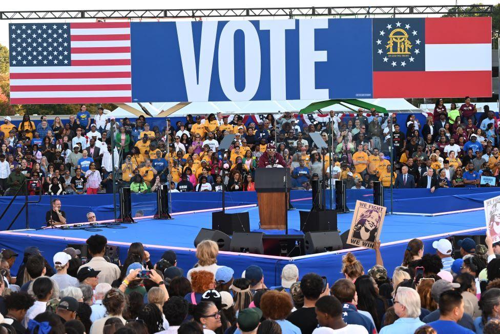 Spike Lee addresses the crowds with big 'VOTE' banner behind