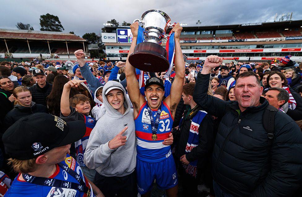 The Bulldogs' Arthur Jones poses with the trophy after winning the 2025 VFL Grand Final between Footscray Bulldogs and Southport Sharks in Melbourne