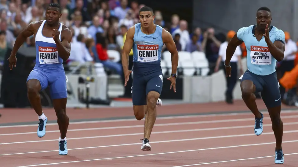 A mid-race image of Joel Fearon sprinting at the London Diamond League alongside British sprinters Adam Gemili and Harry Aikines-Aryeetey.