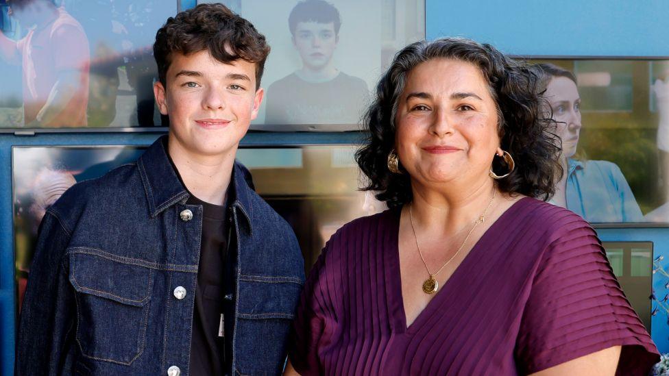 Owen Cooper, wearing a denim jacket, and Shaheen Baig, wearing a purple blouse, attend the 2025 BAFTA Garden Party at British Consulate General Residence on August 16, 2025 in Los Angeles.
