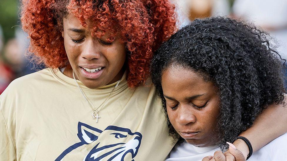 A close up portrait of two women crying at a vigil for the victims at Apalachee High School in Winder, Georgia on 4 September 