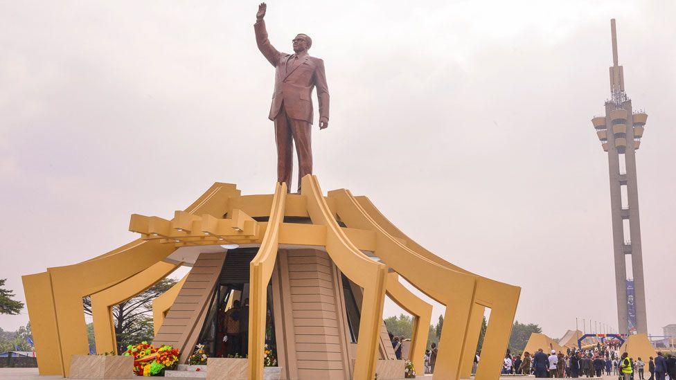 Yellow arches surround the mausoleum of Patrice Lumumba in Kinshasa. His statue stand atop the structure.