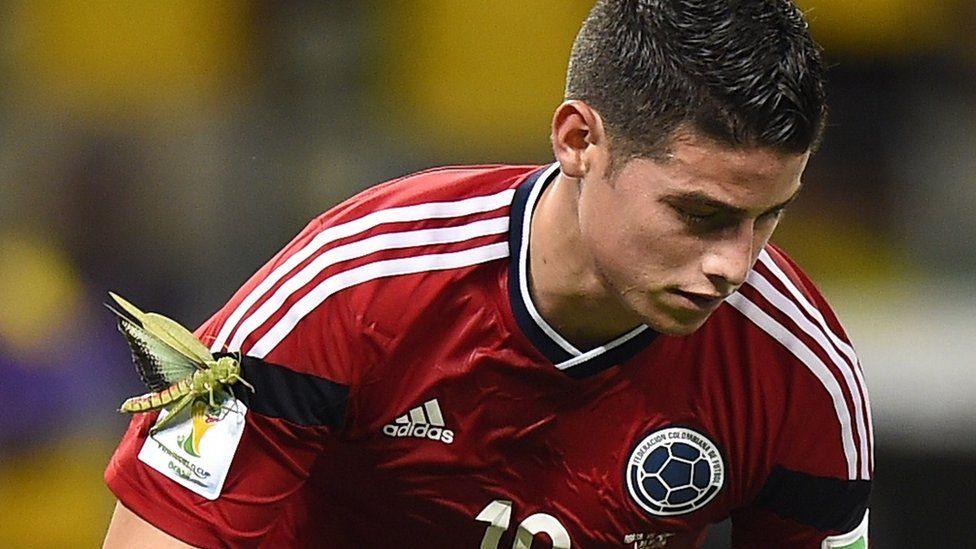 James Rodriguez with a large insect on his arm.