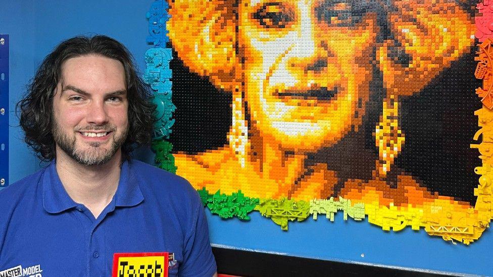 Jacob McPeake stood next to the mosaic he created of Foo Foo Lamar. 