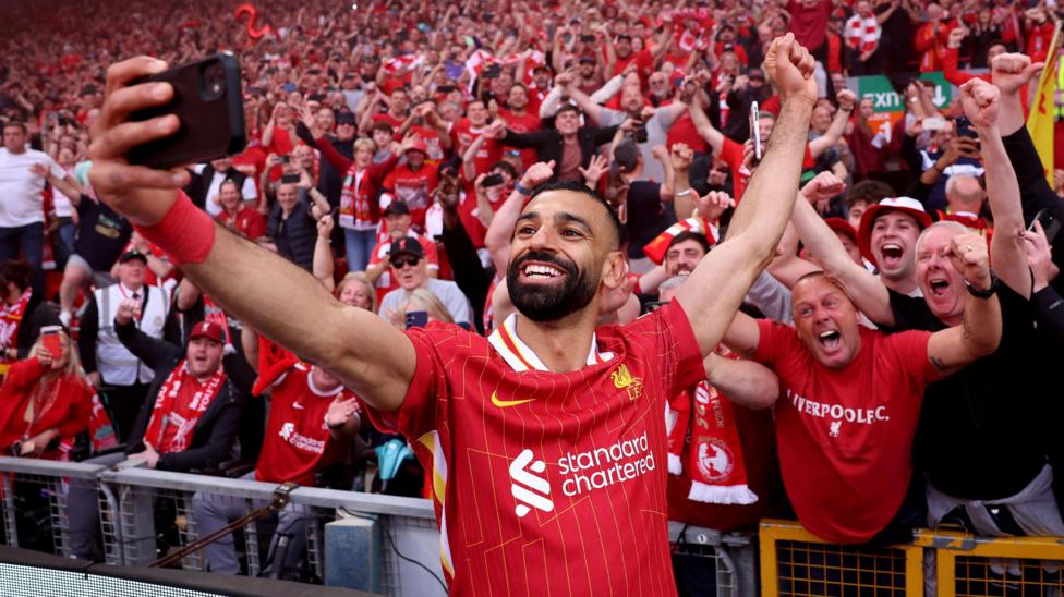 Mohamed Salah takes a selfie with Liverpool fans after winning the title