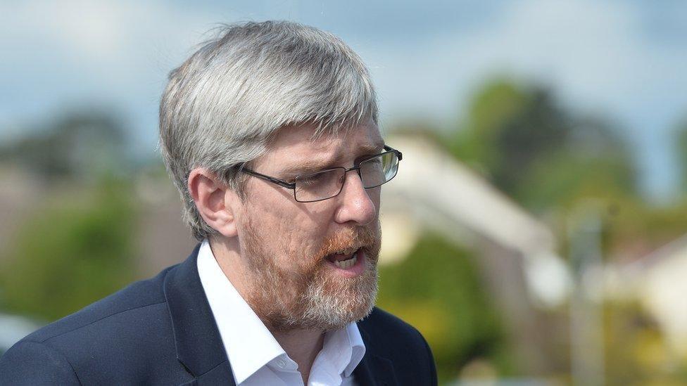 John O'Dowd with grey hair, navy suit blazer and white shirt