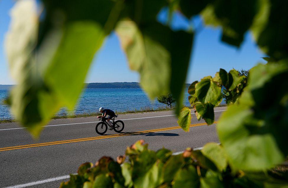 An athlete rides on the bike course during the Ironman 70.3 event in Frankfort, Michigan. Photo by Patrick McDermott