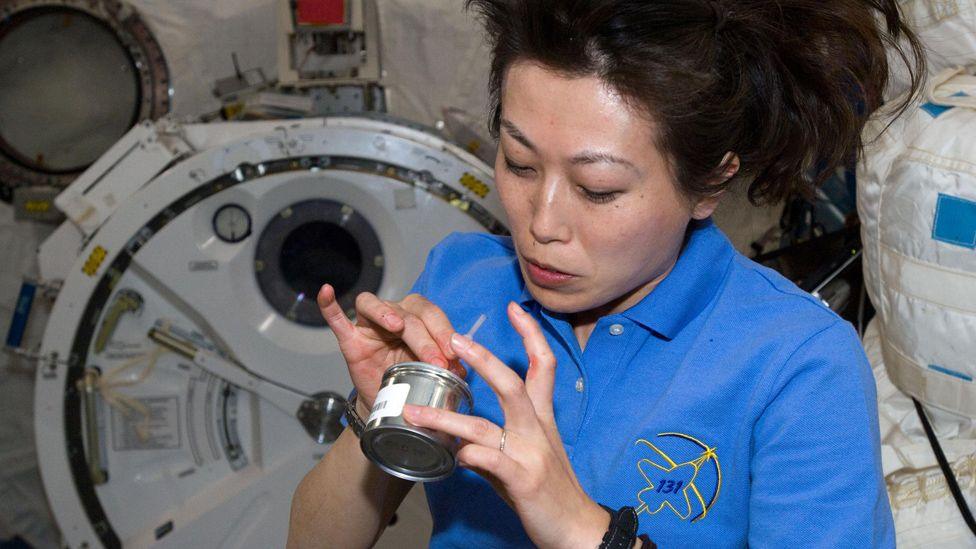 Astronaut Naoko Yamazaki eats a snack on the International Space Station