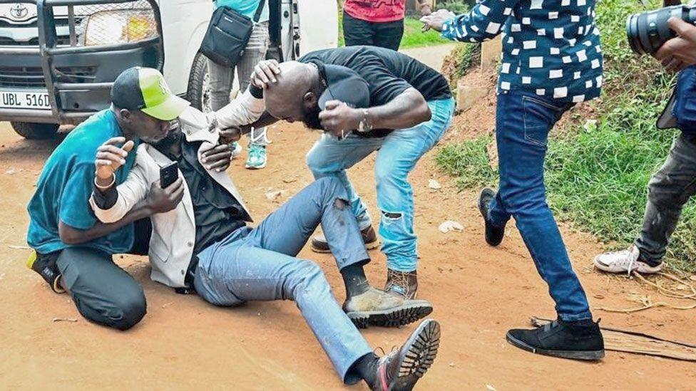 Bobi Wine on the floor after an alleged confrontation with police