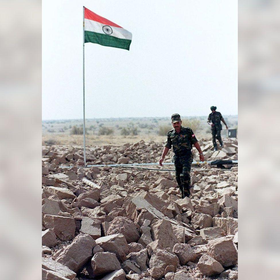 This file photo dated 20 May, 1998 shows Indian soldiers walking on shattered ground as they patrol the edge of the crater at the Shakti-1 site, where an underground nuclear test took place 11 May 1998. North Korea's announcement 09 October, 2006 that it has carried out its threat to explode a nuclear device marks the first real life test of the world's deadliest weapon to take place anywhere in the world since 1998. Nuclear weapons testing has in principle been banned since 1996; only India and Pakistan are known to have detonated devices since then.