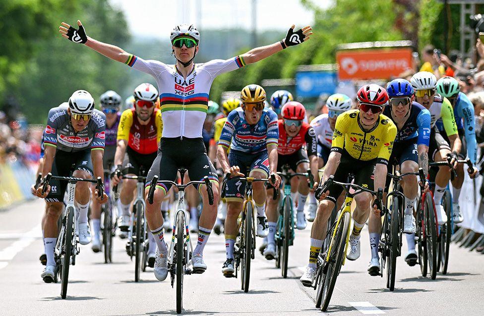 Tadej Pogacar of Slovenia celebrates at the finish line as stage winner of the Critérium du Dauphiné ahead of Jonas Vingegaard in Montlucon, France. Photo by Dario Belingheri