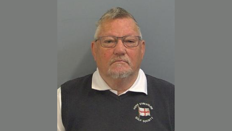 Allen Morgan with short white hair and beard wearing blue Hove Streamline Golf Society top in mug shot
