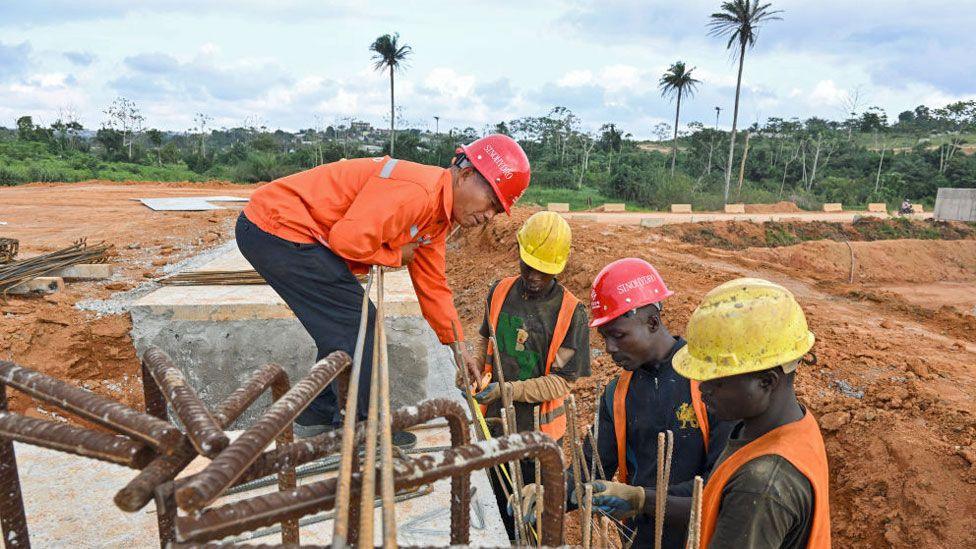 Construction workers work on a highway construction site near Abidjan, Ivory Coast - 4 September 2024