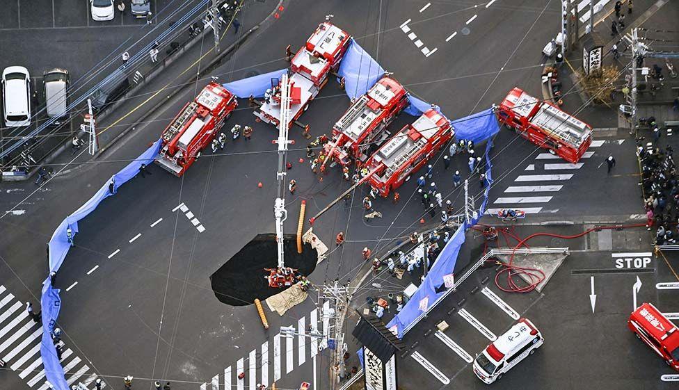 An aerial view shows rescue operations underway at a large sinkhole that swallowed a truck at an intersection in Yashio, north of Tokyo, Japan.  January 28, 2025