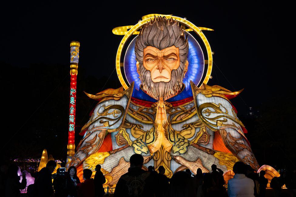 People view "Monkey King" lantern display during the 2025 Greater Bay Area Lantern Festival on January 22, 2025 in Nansha district, Guangzhou City, Guangdong Province of China. A colourful giant illuminated fabric lantern shaped as the character of the monkey king in yellows and blues is seen during the night.