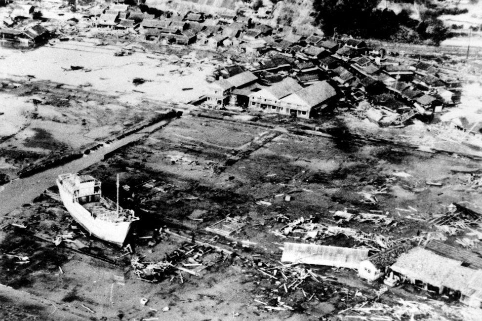 This aerial view shows the small town of Tanabe in the aftermath of an earthquake on Dec. 21 in southern Japan on Dec. 26, 1946. The earthquake and tidal wave has left a ship, left, high and dry and has taken a heavy toll in lives. (AP Photo/U.S. Fifth Airforce)