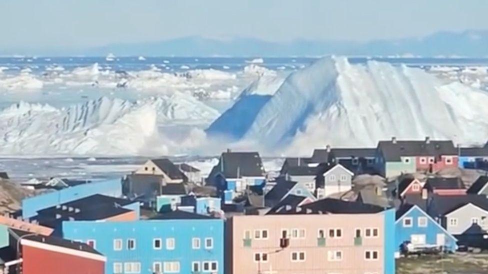 Watch: Giant iceberg turns over near Greenland's coast