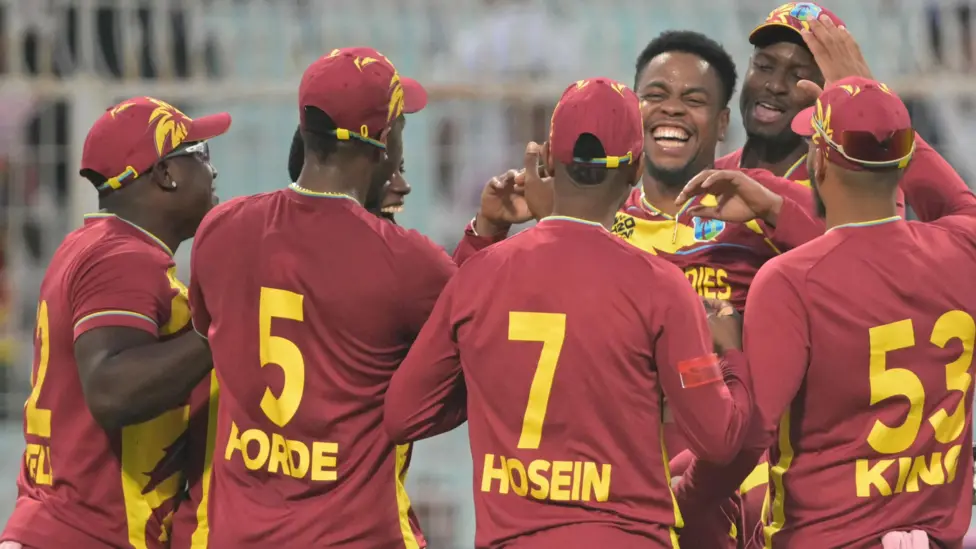 West Indies' Shimron Hetmyer (3R) celebrates with teammates after taking the wicket of Scotland's George Munsey 