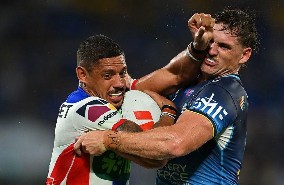 Dane Gagai of the Newcastle Knights is tackled during the round three NRL match against Gold Coast Titans at Cbus Super Stadium on 22 March in Gold Coast, Australia.