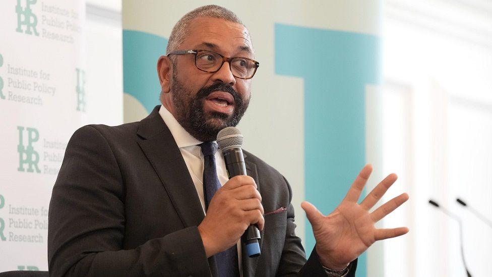 James Cleverly holding a microphone at a think tank event