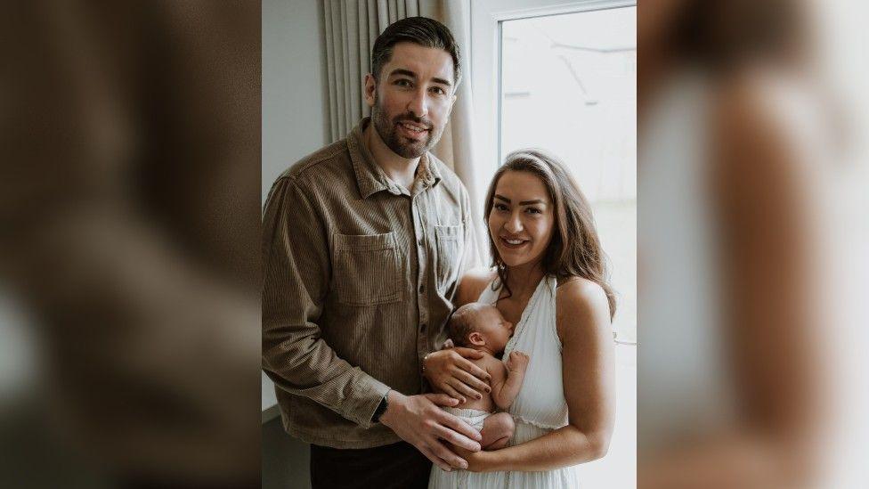 Gabrielle and Tyler holding their baby, Bertie