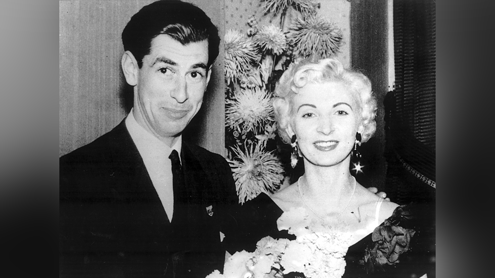 David Blakely and Ruth Ellis pose for a black and white picture in smart attire