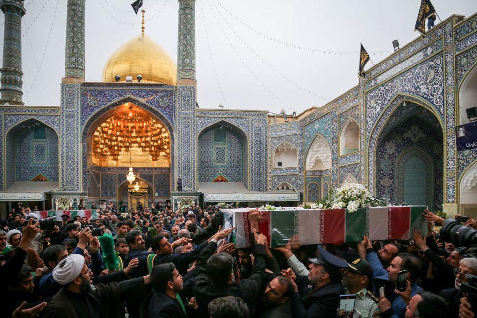 Mourners attend the funeral procession of Iran's President Ebrahim Raisi at the Muslim Shiite Shrine of Masoomeh in Qom, 21 May 2024