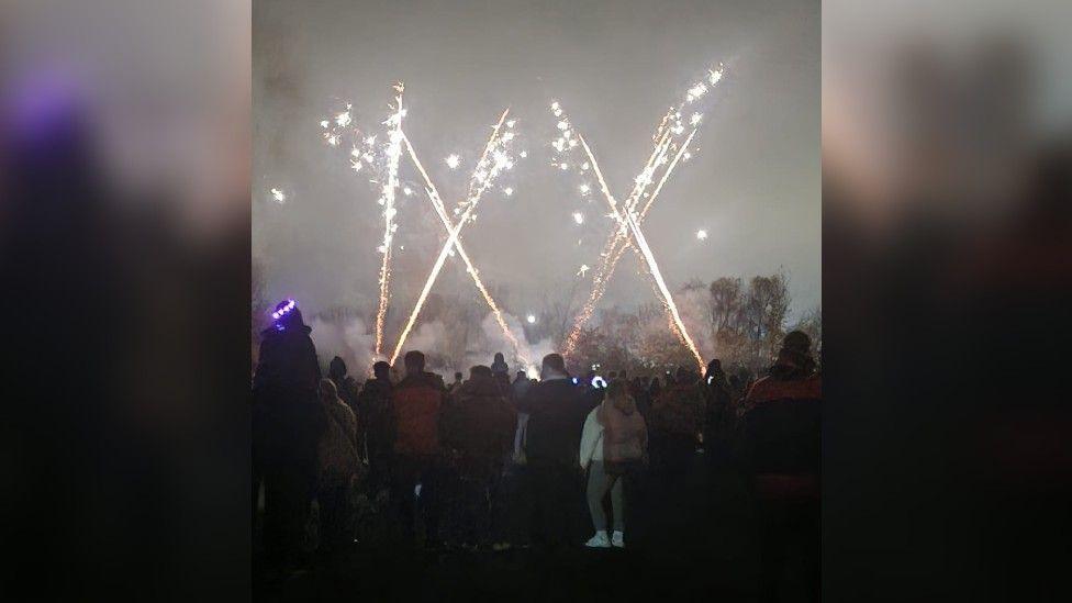 Thousands of people watching a firework show in Chellaston Park, in Derby