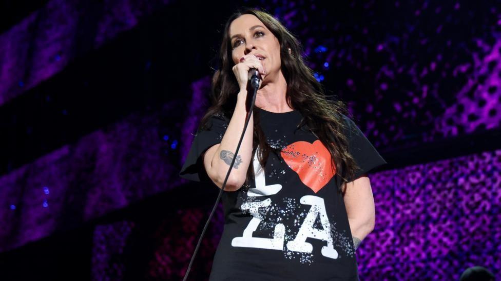 Alanis Morissette was among the performers. She's seen here in a black Love LA tee-shirt while holding a microphone