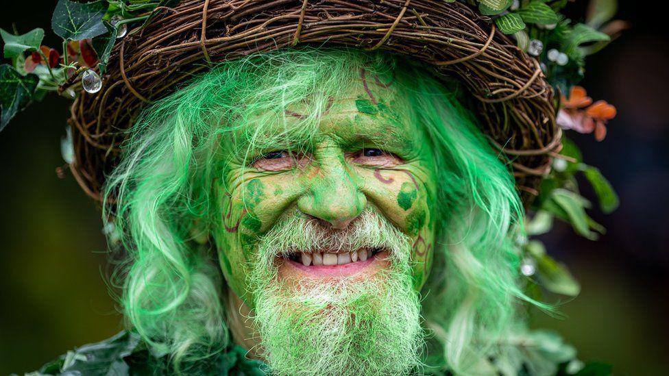 A man dressed as The Green Man.