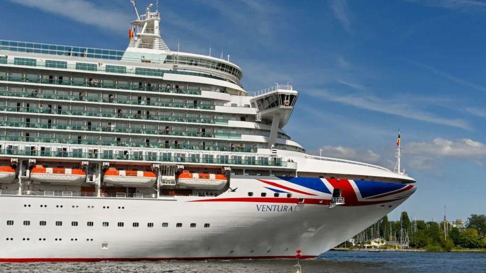 A side view of the front of the Ventura, with a large union jack design plastered across the front of the ship