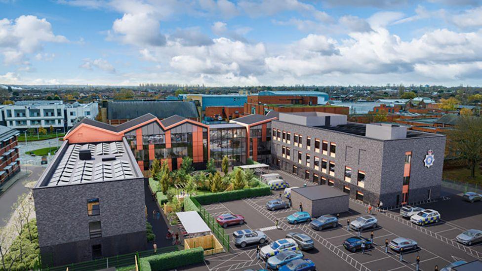 Artist impression of the new police station which is a three-storey U-shaped grey brick building with flat roofs and a car park in the front . In the middle section is a glass and red tiled building with a pitched roof