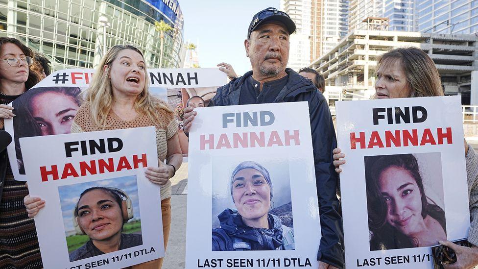 Ryan Kobayashi with three other women hold pictures of his missing daughter Hannah Kobayashi at a demonstration in Los Angeles in November 2024