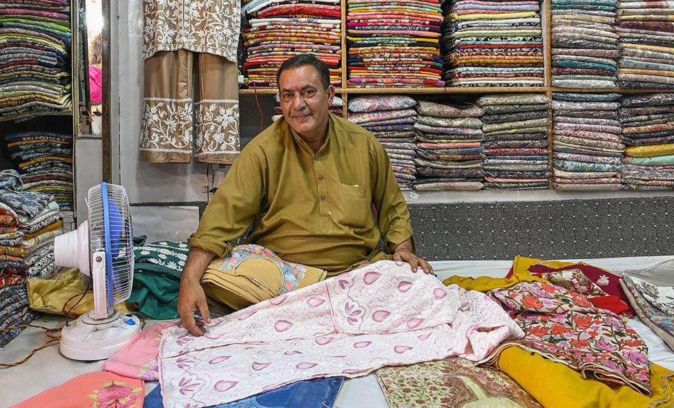 Fayyaz Ahmad sells Kashmiri embroidered shawls and dresses in Pahalgam's main market