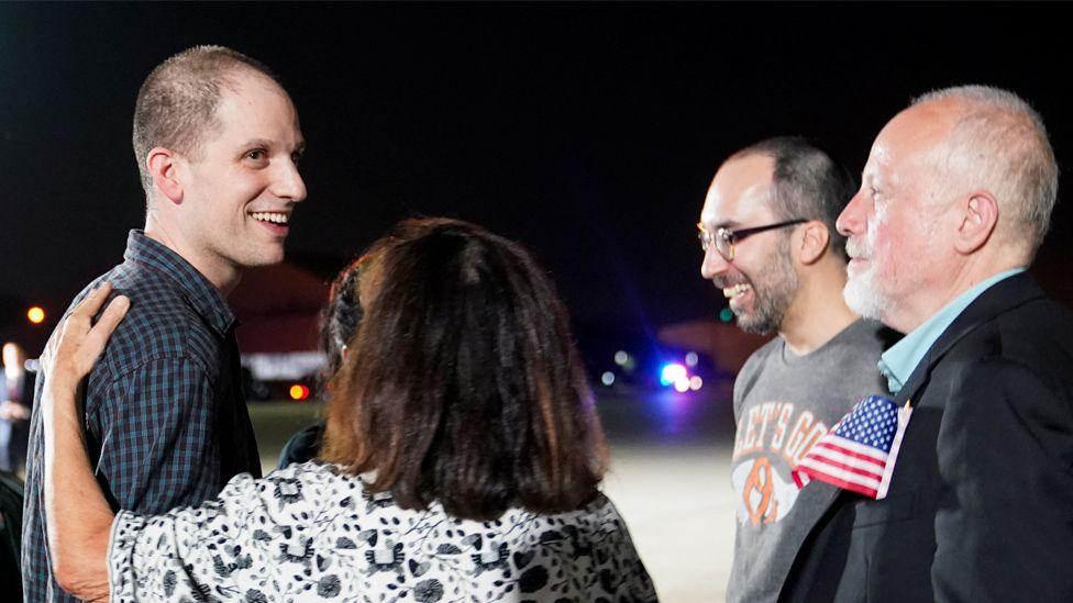 Evan Gershkovich speaks with his family following his release