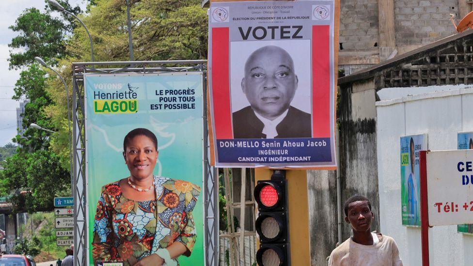 Campaign billboards for Ahoua Don Mello and Henriette Lagou Adjoua seen on a street in Ivory Coast.