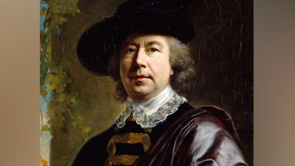 A self-portrait by 18th Century artist Nathanial Hone showing him in a black broad brimmed hat, wearing a lace collar over a black jacket with a purple cape on one shoulder looking towards the viewer