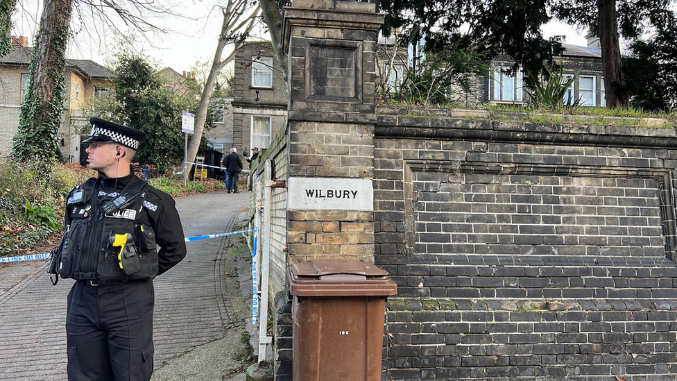 A police officer outside Norwich Road property