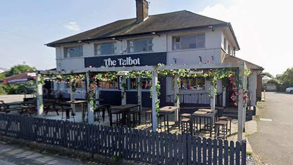 The Talbot on Balshaw Lane in Euxton. A large detached white two storey pub with pergolas and seating to the front